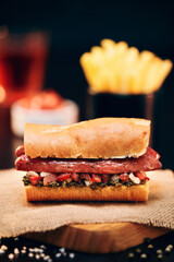 Argentinian choripan with chimichurri and creole sauce.