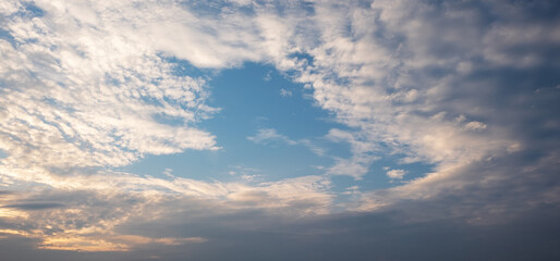 Colorful sunset and sunrise with clouds.Blue and orange color of nature.Many white clouds in the blue sky.The weather is clear today.sunset in the clouds.The sky is twilight.