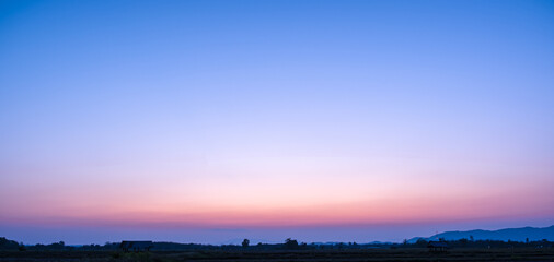 Colorful sunset and sunrise with clouds.Blue and orange color of nature.Many white clouds in the blue sky.The weather is clear today.sunset in the clouds.The sky is twilight.