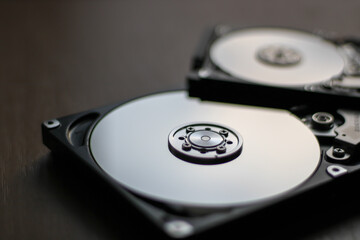Fototapeta Disassembled hard drive from the computer with mirror effect. Opened hard drive from the computer hard disk drive (HDD) obraz