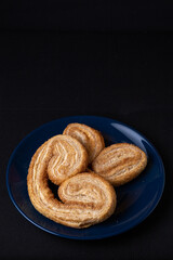 Palmier cookie highlighted on dark background
