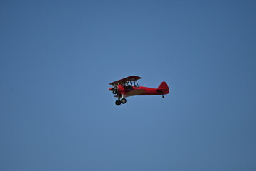 Fototapeta na wymiar A world war II biplane flying in the blue sky