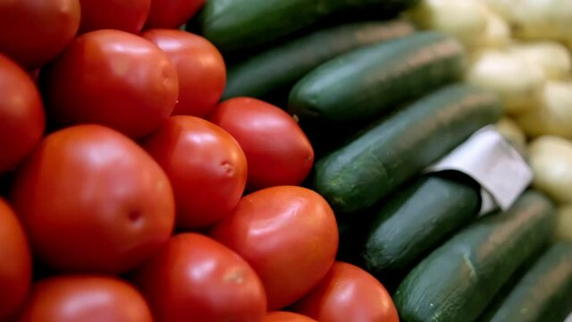 Colorful vegetables stand with tomatoes, cucumbers, and potatoes
