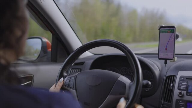 Video, woman hands drive a car, fingers lie on the steering wheel, beautiful fingers female hands