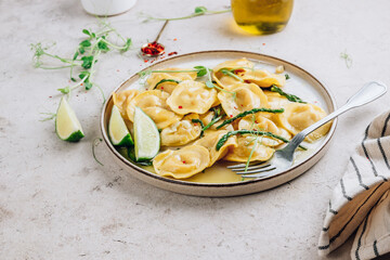 Italian cheese ravioli with roasted asparagus in herbed lemon butter sauce