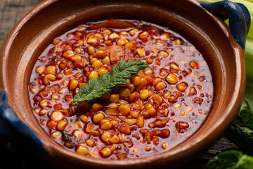 Red corn esquites on wooden background. Mexican food