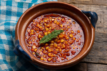 Red corn esquites on wooden background. Mexican food