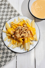 Animal style fries with cheese and caramelized onion on white background