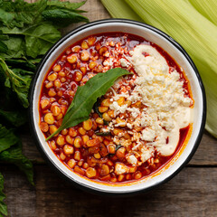 Red corn esquites on wooden background. Mexican food
