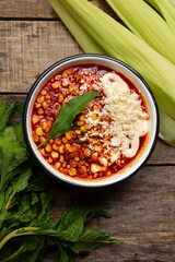 Red corn esquites on wooden background. Mexican food