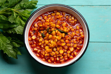 Red corn esquites on turquoise background. Mexican food