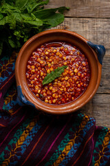 Red corn esquites on wooden background. Mexican food