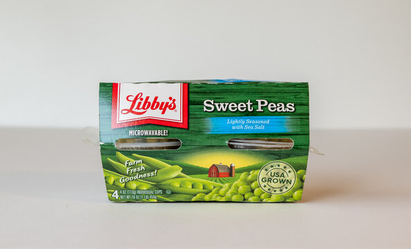 BEMIDJI, MN - 17 NOV 2020: Package of Libbys Sweet Peas in four plastic containers. The label says it is microwavable and lightly seasoned with sea salt and USA Grown.