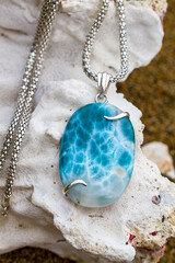 Larimar necklace on coral background
