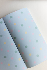 open scrapbooking paper sampler, feat. green pink and yellow dots - backgrounds - photo graphed from above with ambient daylight - space for text