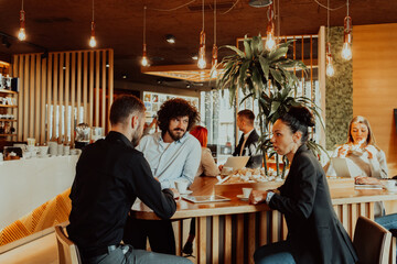 A group of friends hanging out in a cafe, and among them is a tablet.