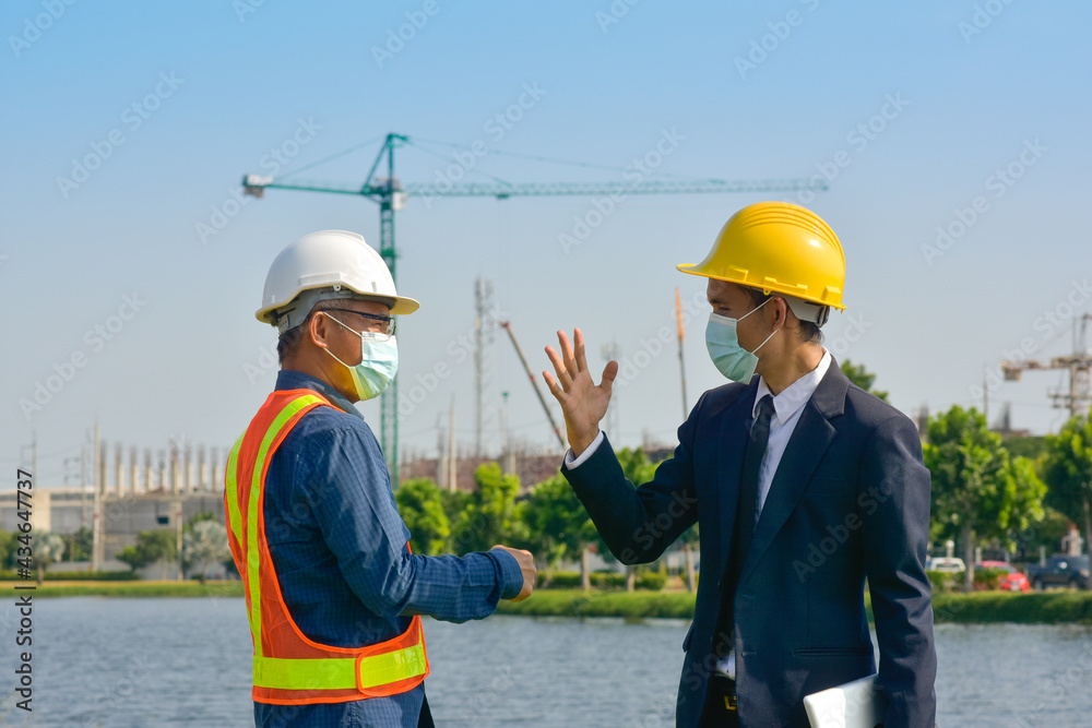 Wall mural two people engineer teamwork outdoor working on site construction