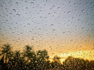 Raindrops on the mirror against the sunset background