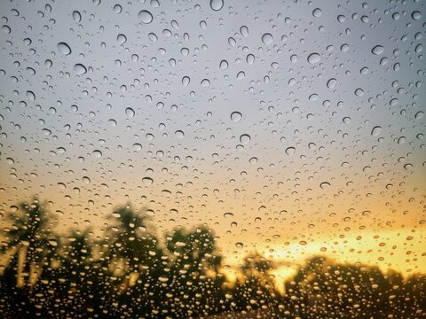 Raindrops on the mirror against the sunset background