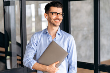 Portrait of a handsome confident successful caucasian businessman or office employee, wearing shirt...