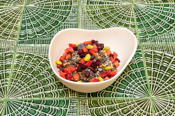 Lentil salad with bell pepper, strawberries, green beans and beets in a white bowl