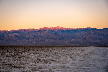First Light Hits the Mountain Tops Above Badwater Basin