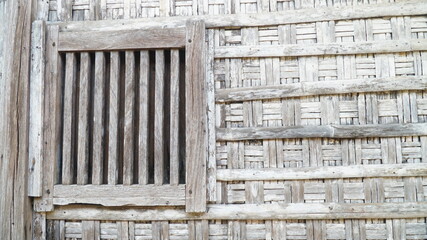 The walls of the house made of woven bamboo, windows made of wood