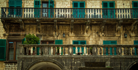 balcony on a building in Kotor with green shutters
