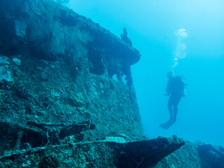 Silhouette of a diver near the wheelhouse of a sunken ship at the bottom of the Indian Ocean © Sergey