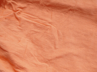 Background texture of fabric cotton linen orange color. Copy space for your text and design. Textile concept and soft backdrop, Flat lay.