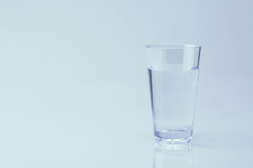 The glass is not full of water. isolated on white