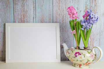 Blooming hyacinths and picture frame with copy space for mockup