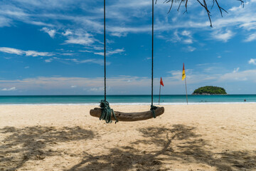 Self made swing on tropical beach bright sunny day