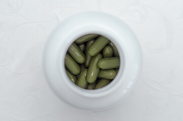 sport and diet concept - vitamins in a jar, top view