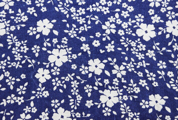 fabric pattern with classical image of the colorful flowers on blue background.