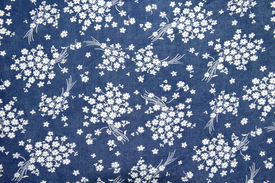 fabric pattern with classical image of the colorful flowers on blue background.