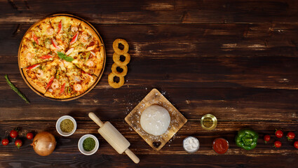 Banner of tray of homemade seafood pizza with tomatoes, fried onion, oregano, rolling pin, dough, olive oil, powder, ketchup, bell peppers located in row below the wooden background with copy space.