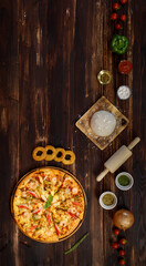 Banner of tray of homemade seafood pizza with tomatoes, fried onion, oregano, rolling pin, dough, olive oil, powder, ketchup, bell peppers located in row below the wooden background with copy space.