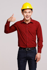 Happy builder showing thumb up in studio