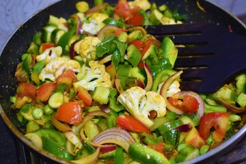 cooking Indian food mixed vegetable on gas closeup