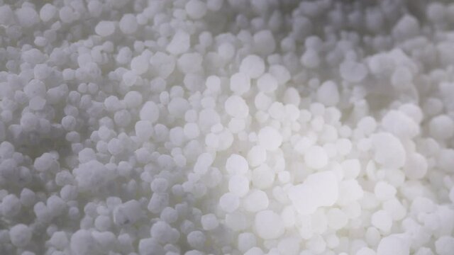 Melting sugar isomalt in a saucepan. Sugar caramelization. Sugar mass to produce candy. Close up.
