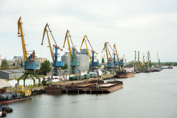 Fototapeta na wymiar river port with cranes, moored ships, barges, railway wagons