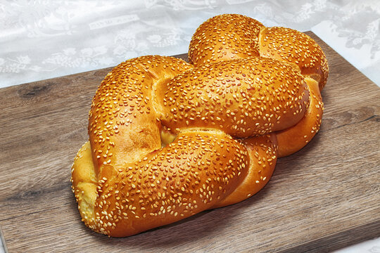Challah or Hallah - Jewish bread. Inscription on the tablecloth in Hebrew: Shabbat Shalom - Jewish and Israeli greetings
