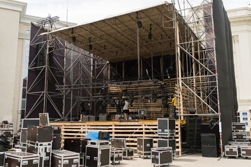 workers assemble a mobile stage for a concert in the city