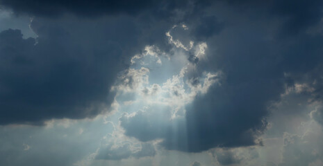 sunray light through down from rain cloud during sunset time