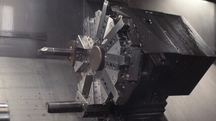 Turning lathe in action. Facing operation of metal blank on turning machine with cutting tool. Old turning lathe machine in turning workshop. Machining high precision mold part by cnc