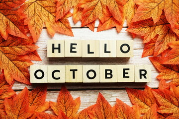 Happy October alphabet letter with maple leaves decoration on wooden background © may1985