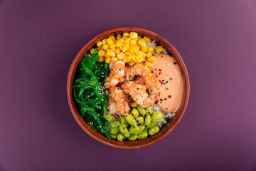 Hawaiian shrimp poke bowl with vegetables on purple background