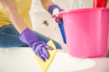 Young woman cleaning her bathroom