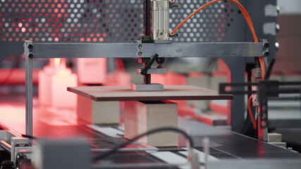 Automatic robotic Conveyor line for the production of boxes. Modern factory of production cardboard box. Manufacture of cardboard boxes from paper. Enterprise for production package